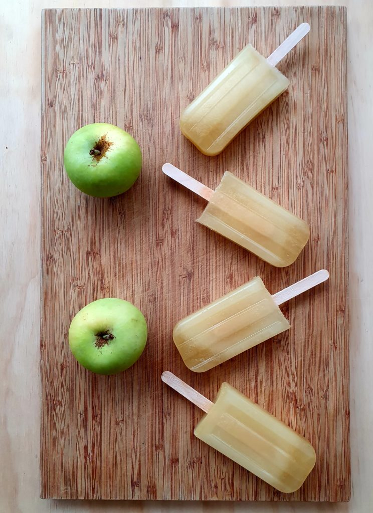 Apple popsicles on board with applies