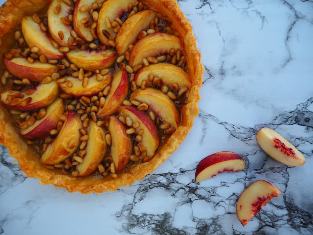Tart on board with nectarine slices