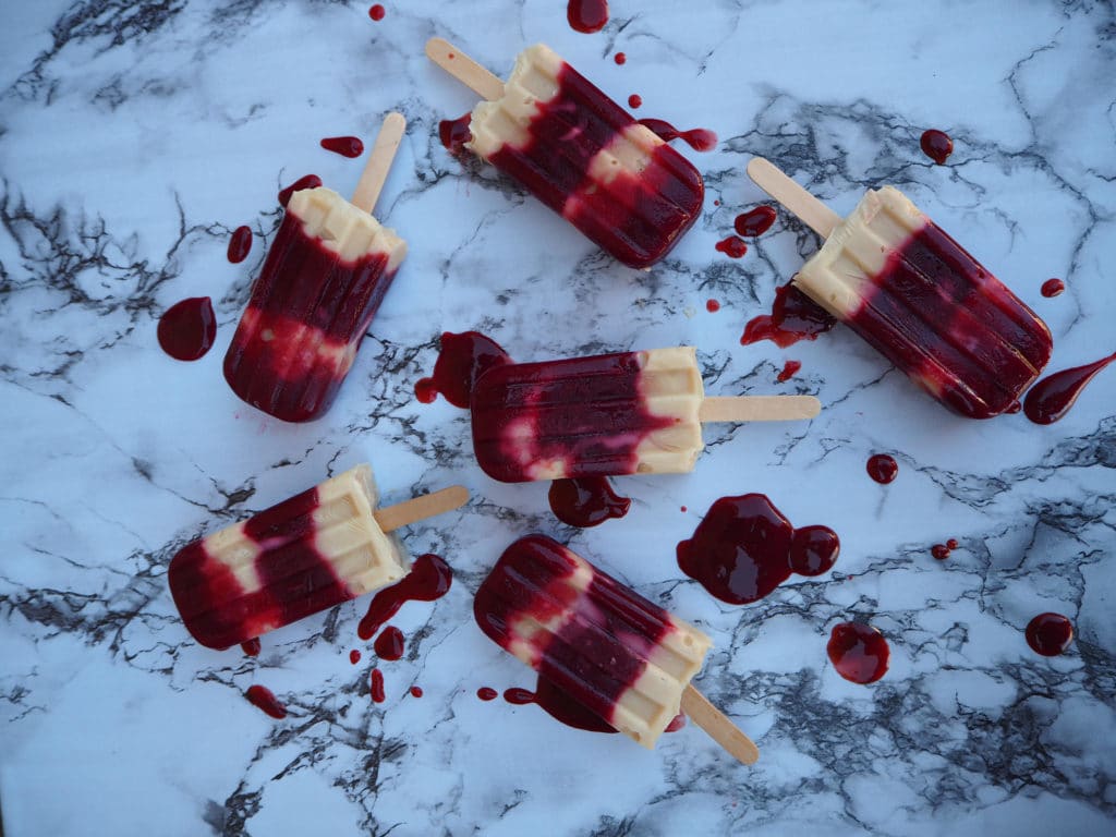 Plum and cashew yogurt popsicles 1 Blood plum and cashew yogurt popsicles on marble board