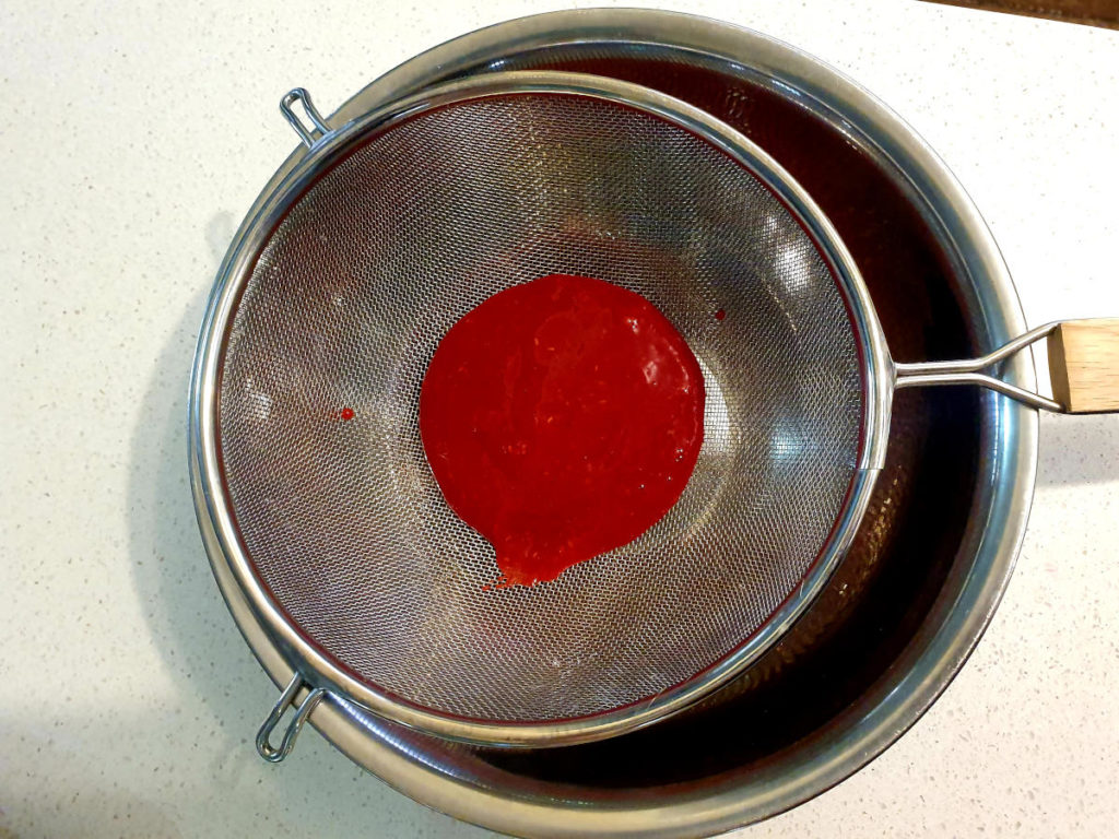 Raspberry lemon kombucha popsicles 3 Straining blitzed raspberries