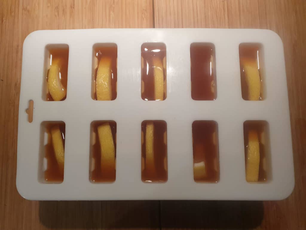 Adding tea mix to popsicle moulds