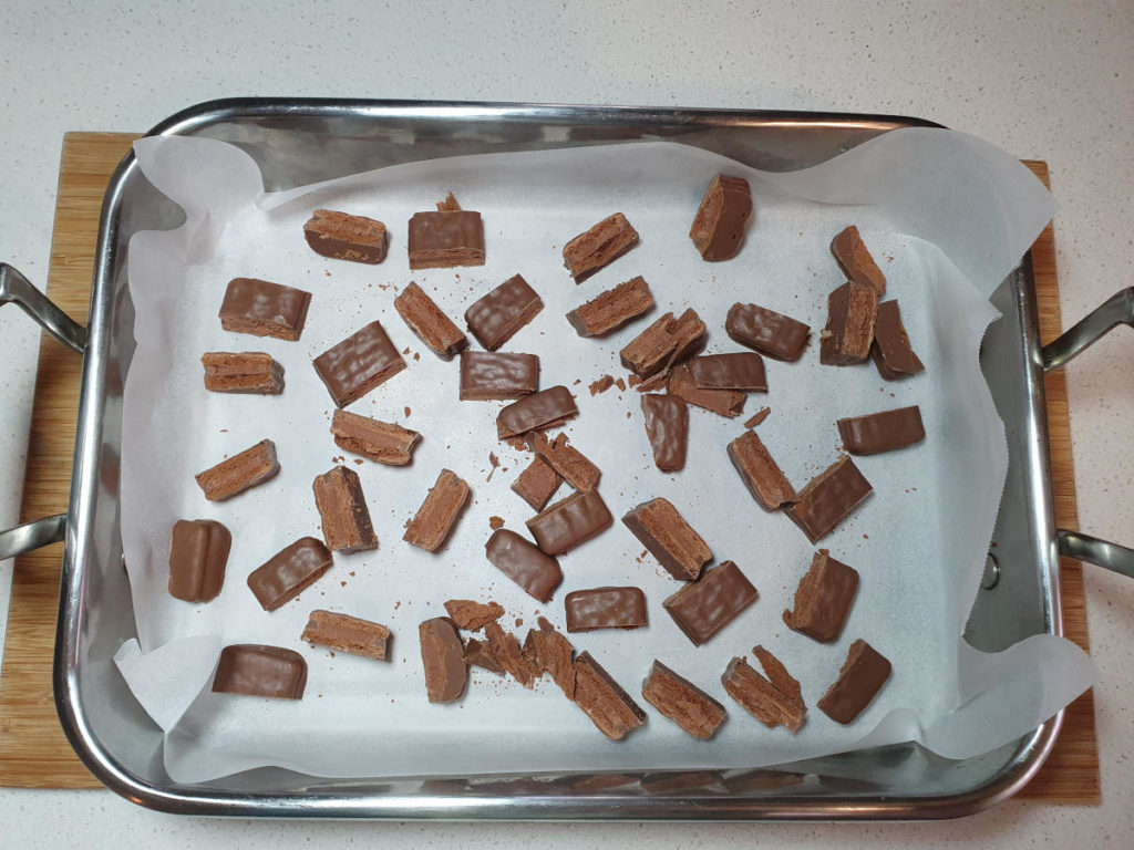 Lined tray with chopped Tim Tams