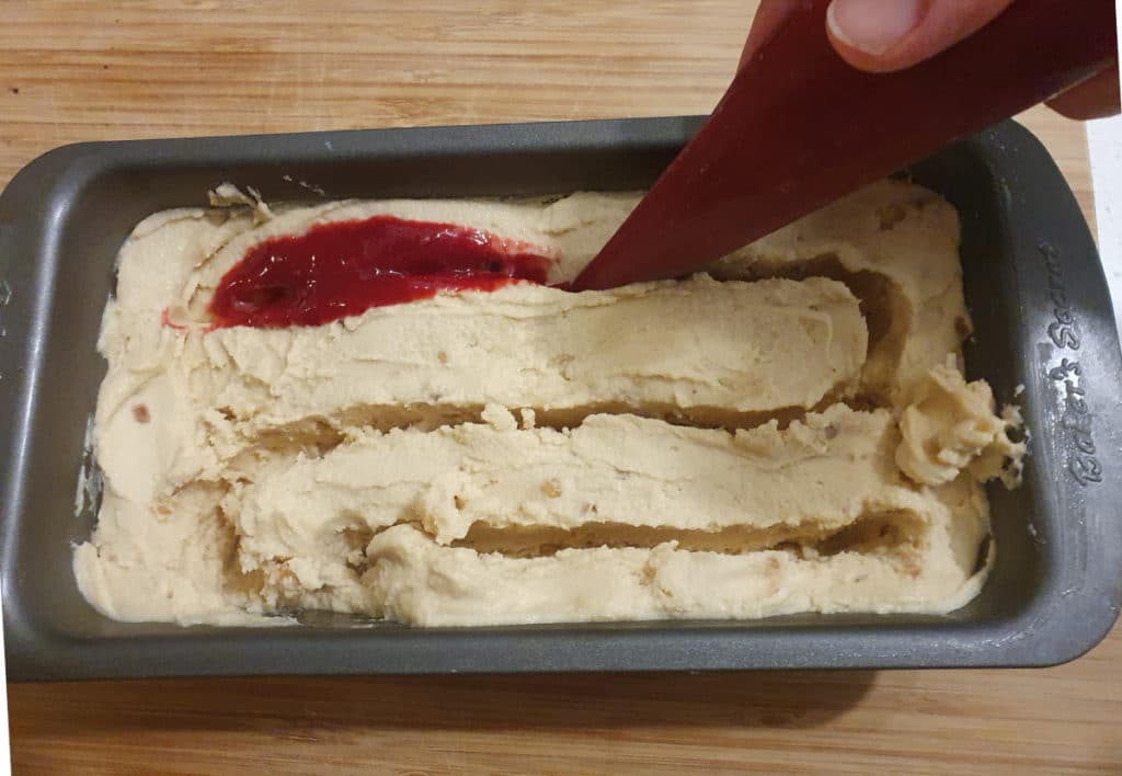 Piping jelly into ice cream