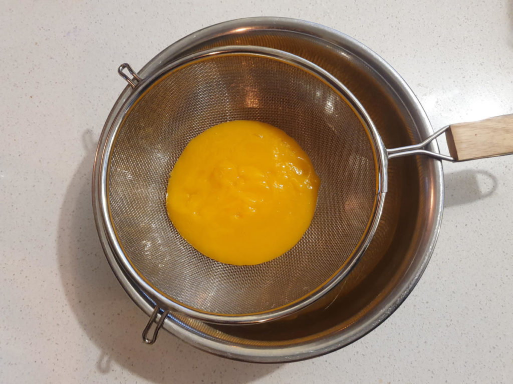 Mango coconut popsicles 4 Straining blitzed mango