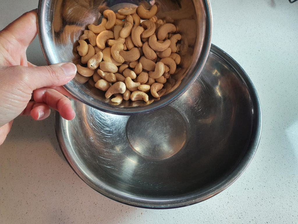 Adding raw cashews to bowl