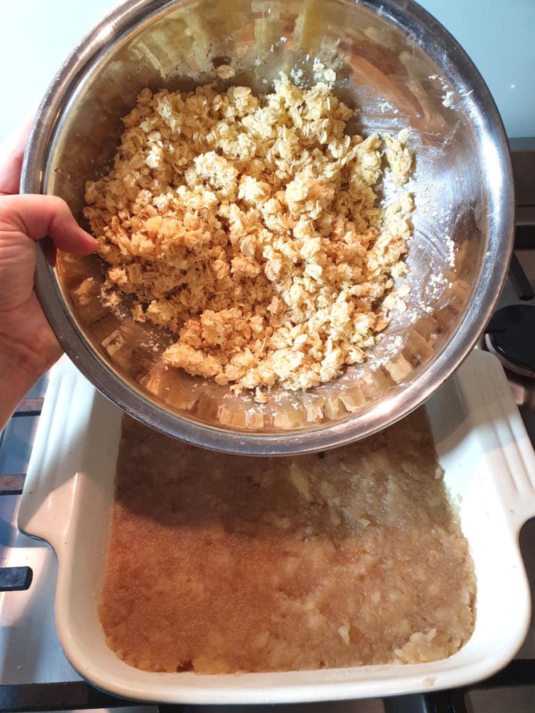 Adding topping mix to crumble