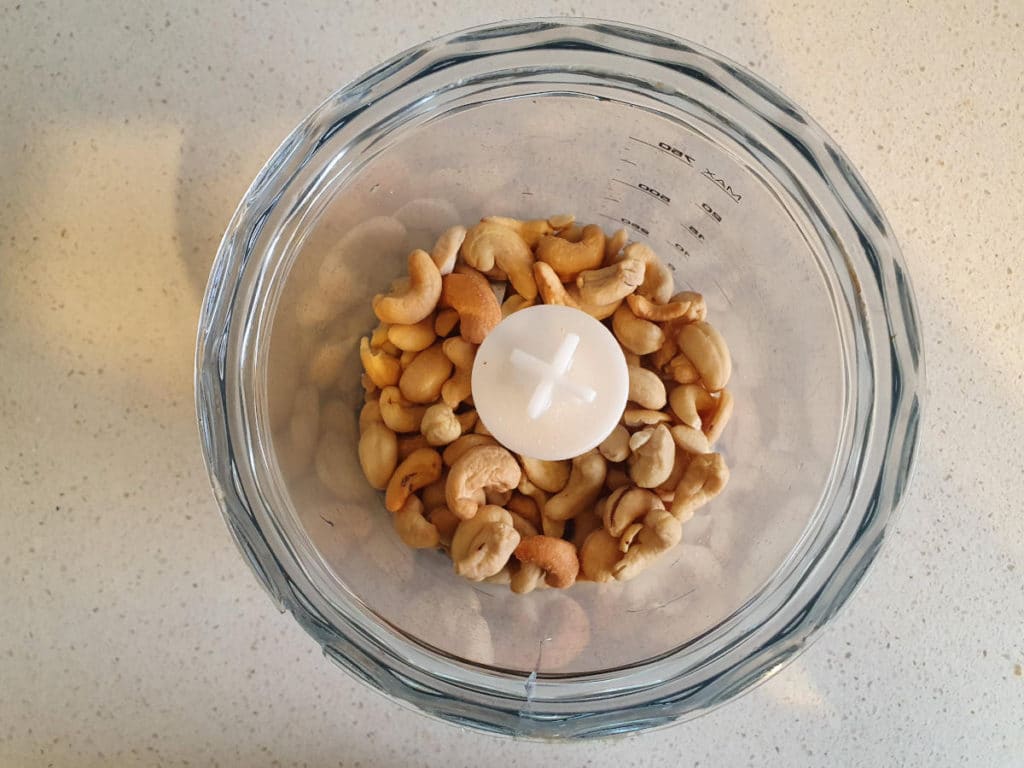 Roast cashews in chopping bowl