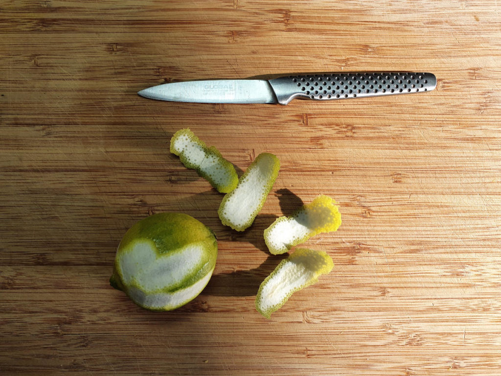 Cutting zest strips off limes
