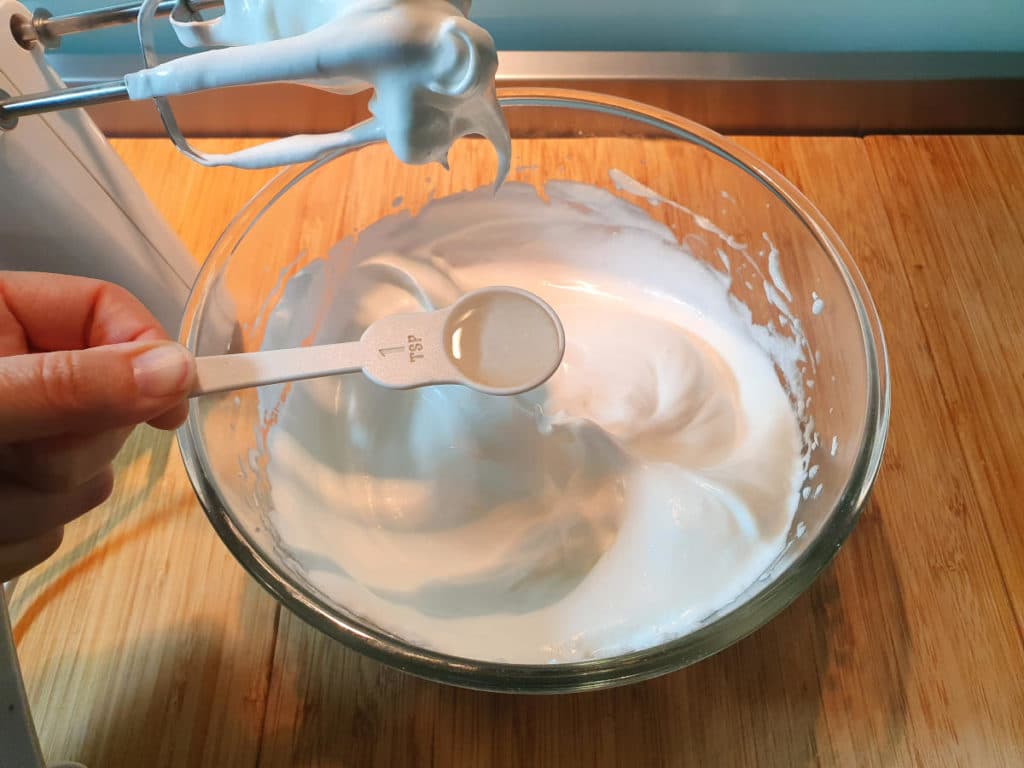 Adding vinegar to meringue mix