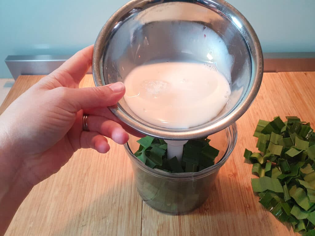 adding milk and pandan to chopping bowl