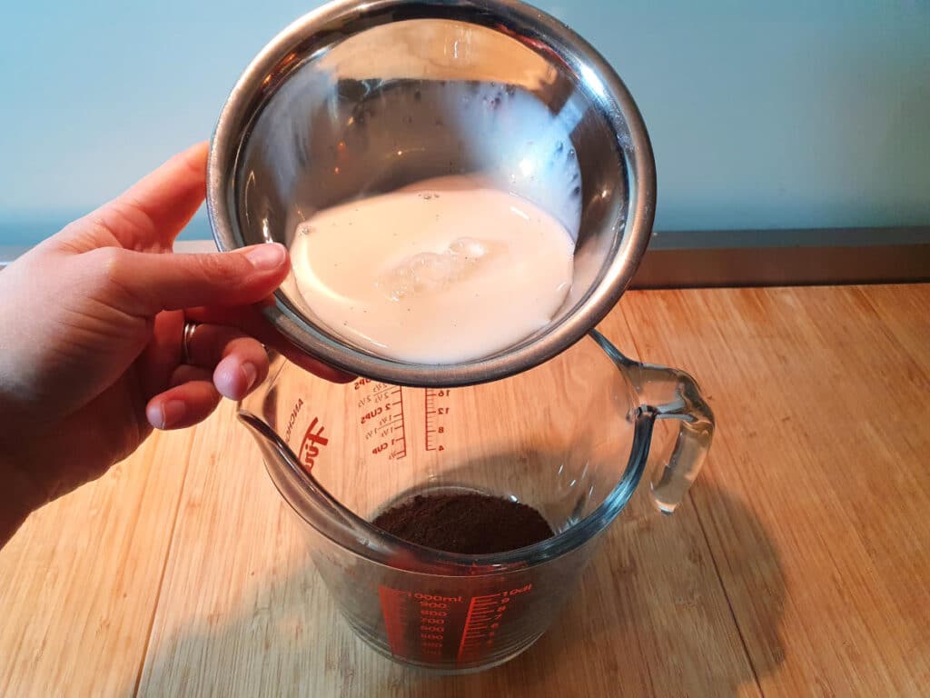 adding milk to coffee