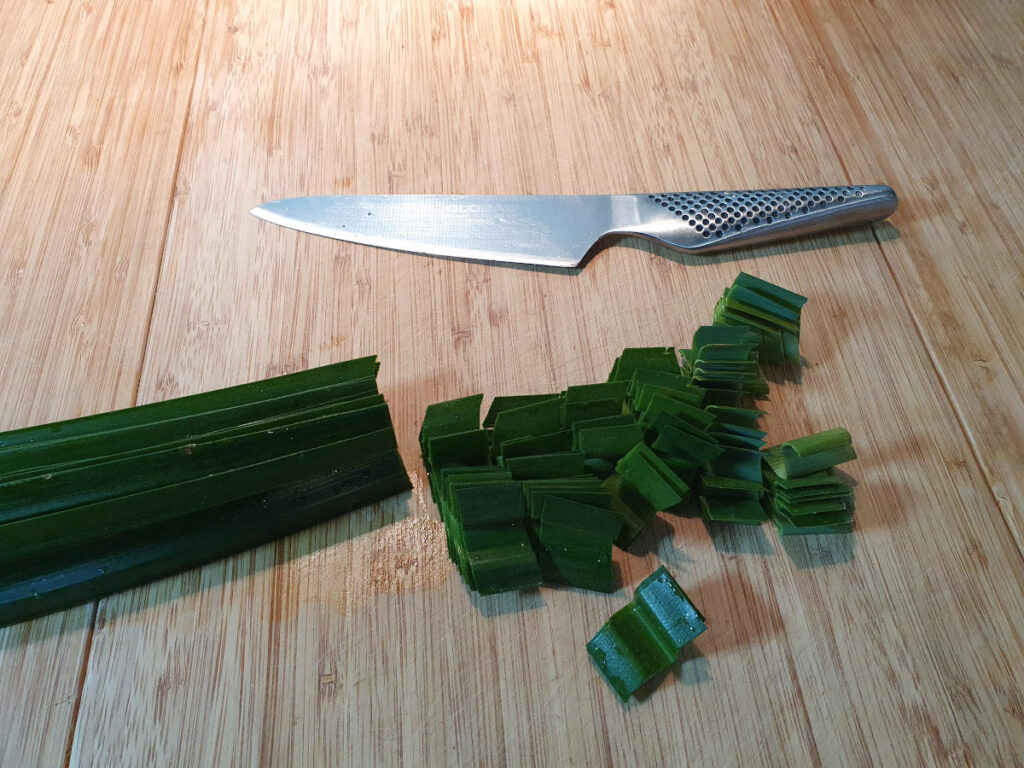 chopping up pandan leaves