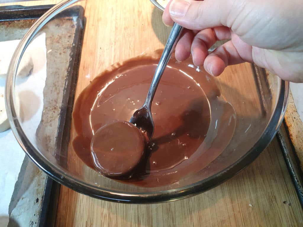 dipping bites into chocolate