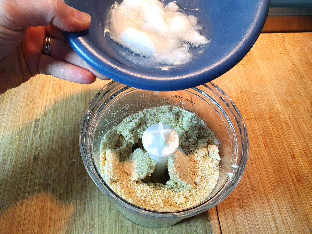 adding melted coconut oil to cashew breadcrumbs