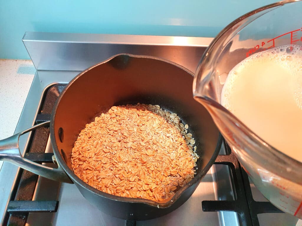 adding oat milk to pan