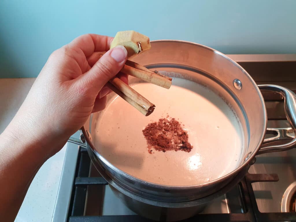 Masala chai ice cream 13 Adding cinnamon and ginger to ice cream mix in double boiler on stove top