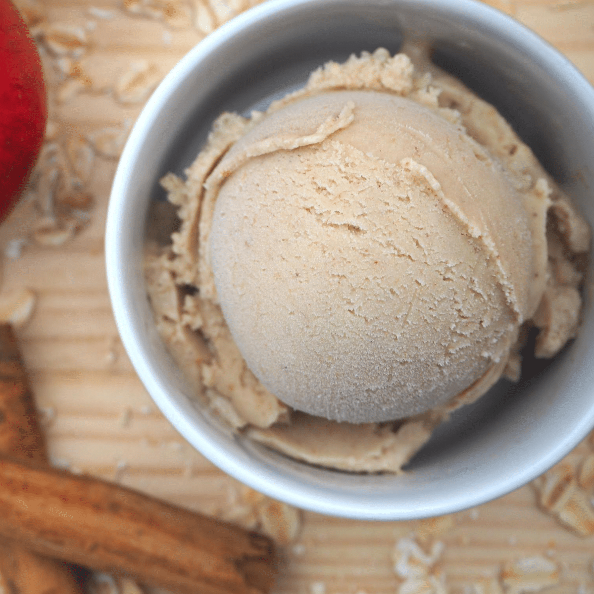 Close up scoop apple cinnamon oat ice cream with apple and cinnamon sticks