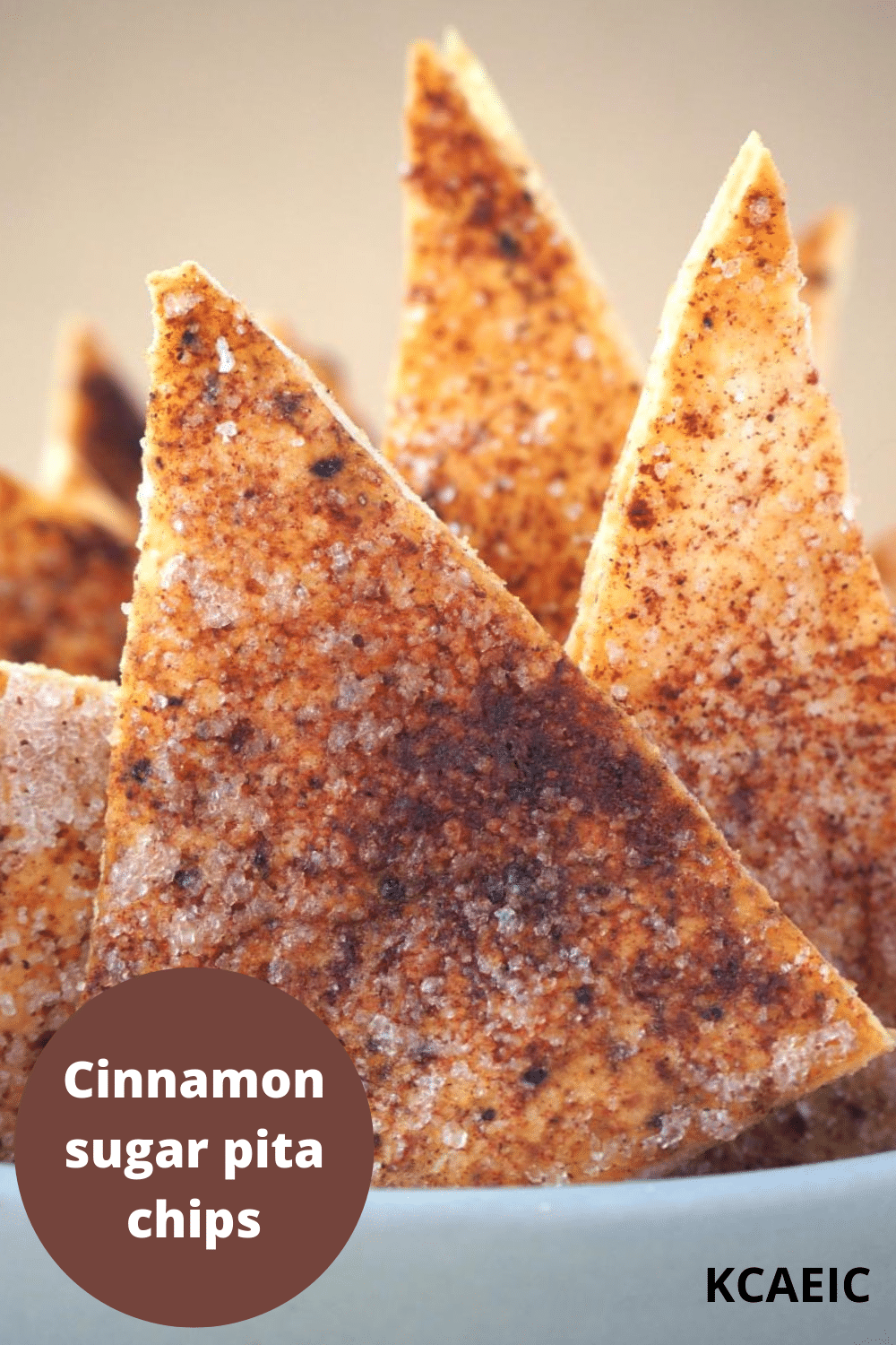 close up of cinnamon sugar pita chips in a bowl with text overlay.