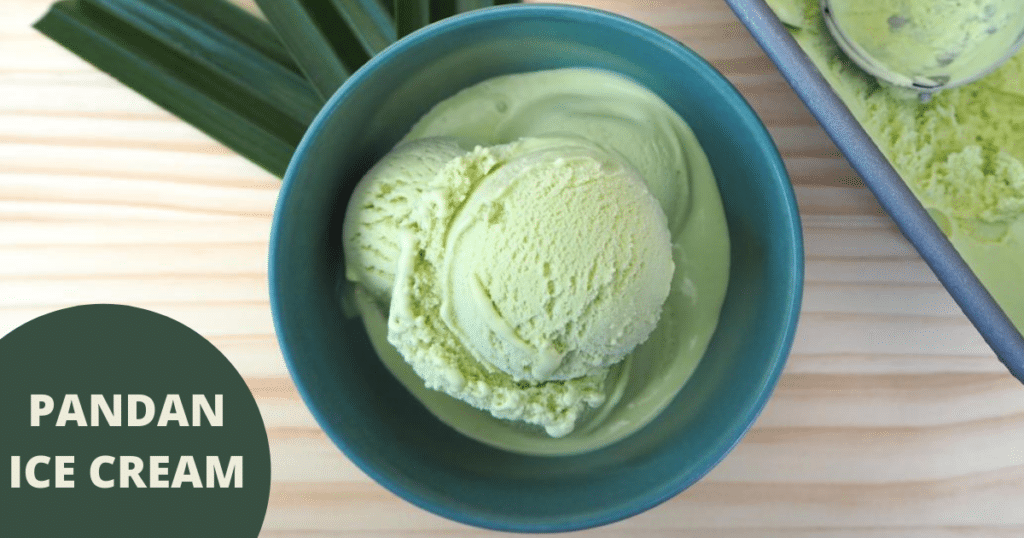 Pandan ice cream in green bowl on brown background with leaves and ice cream in pan with scoop