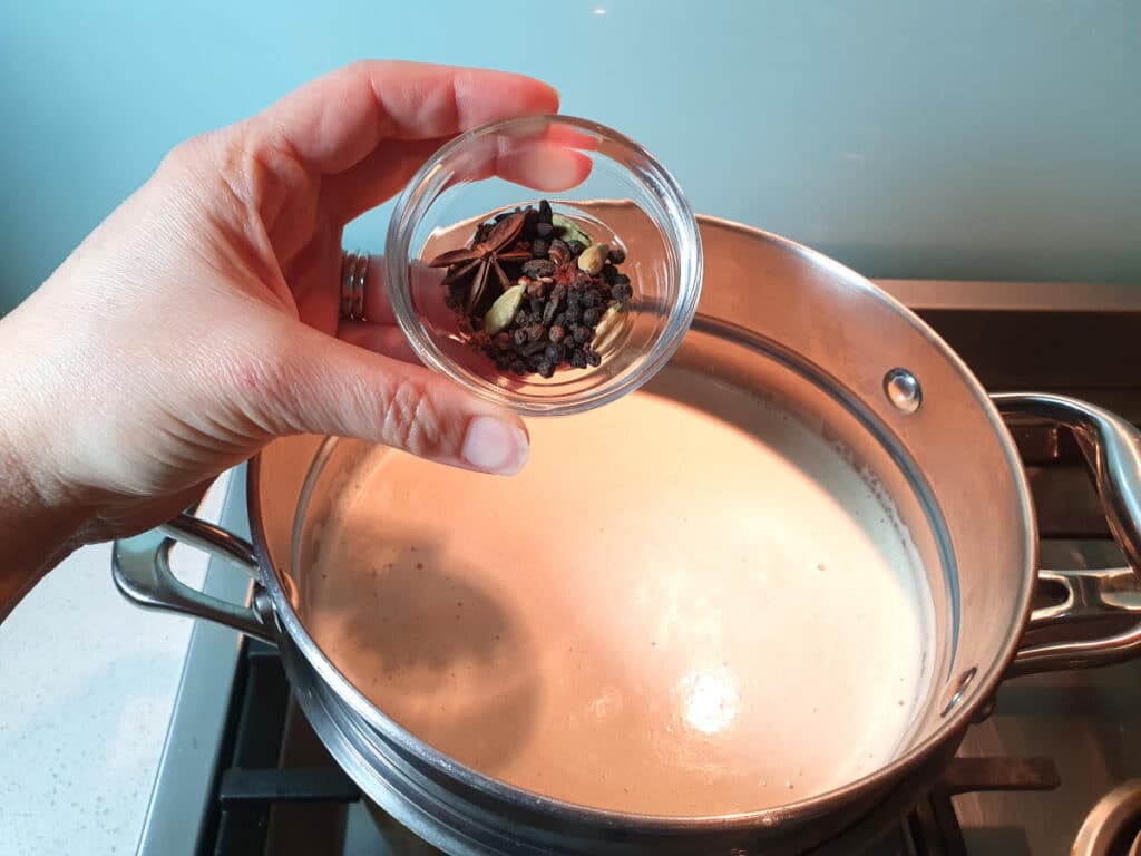 Masala chai ice cream 12 Adding spices to ice cream mix in double boiler on stove top