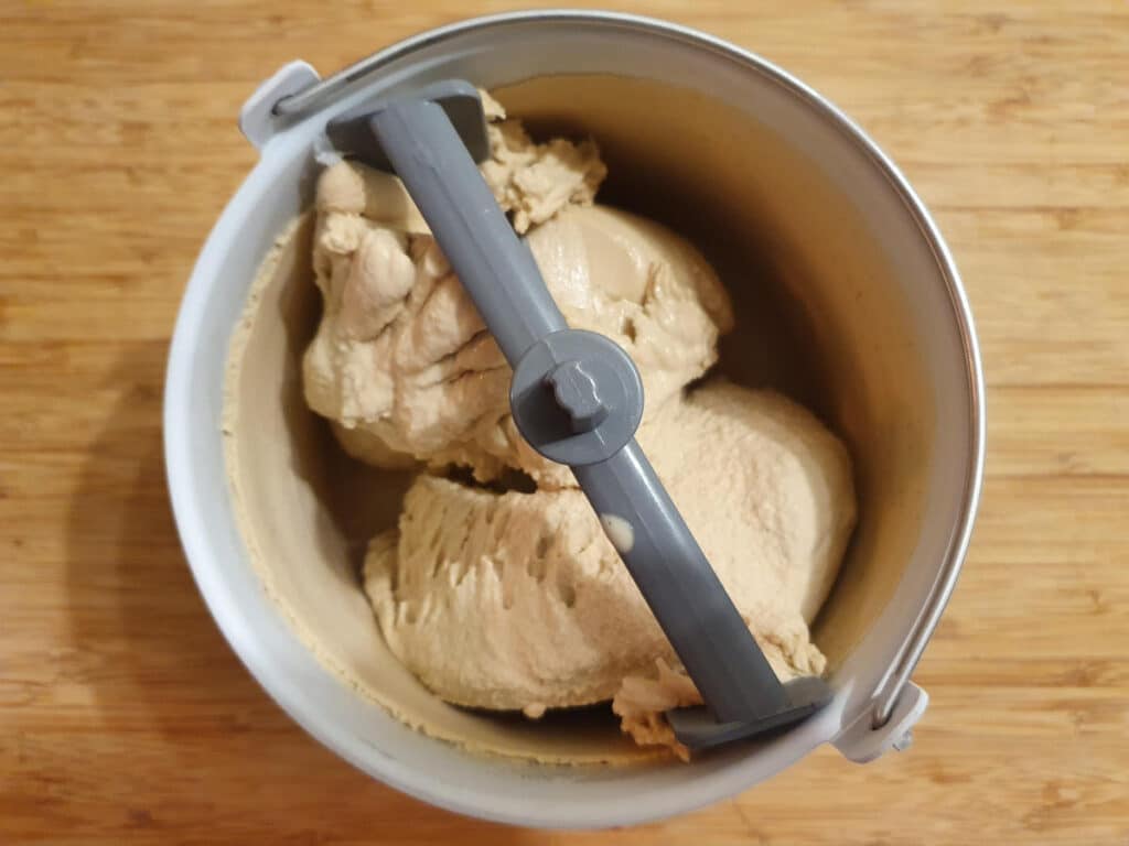churned ice cream in churner bowl on chopping board