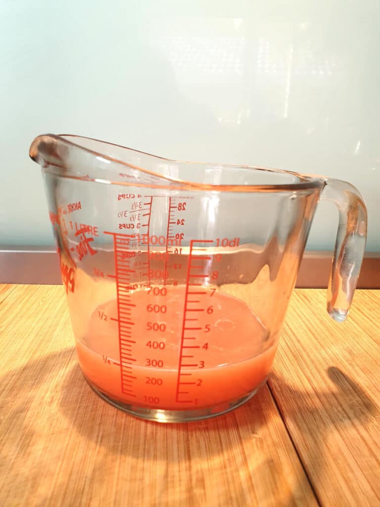 jug with ruby grapefruit juice about 1 cup full