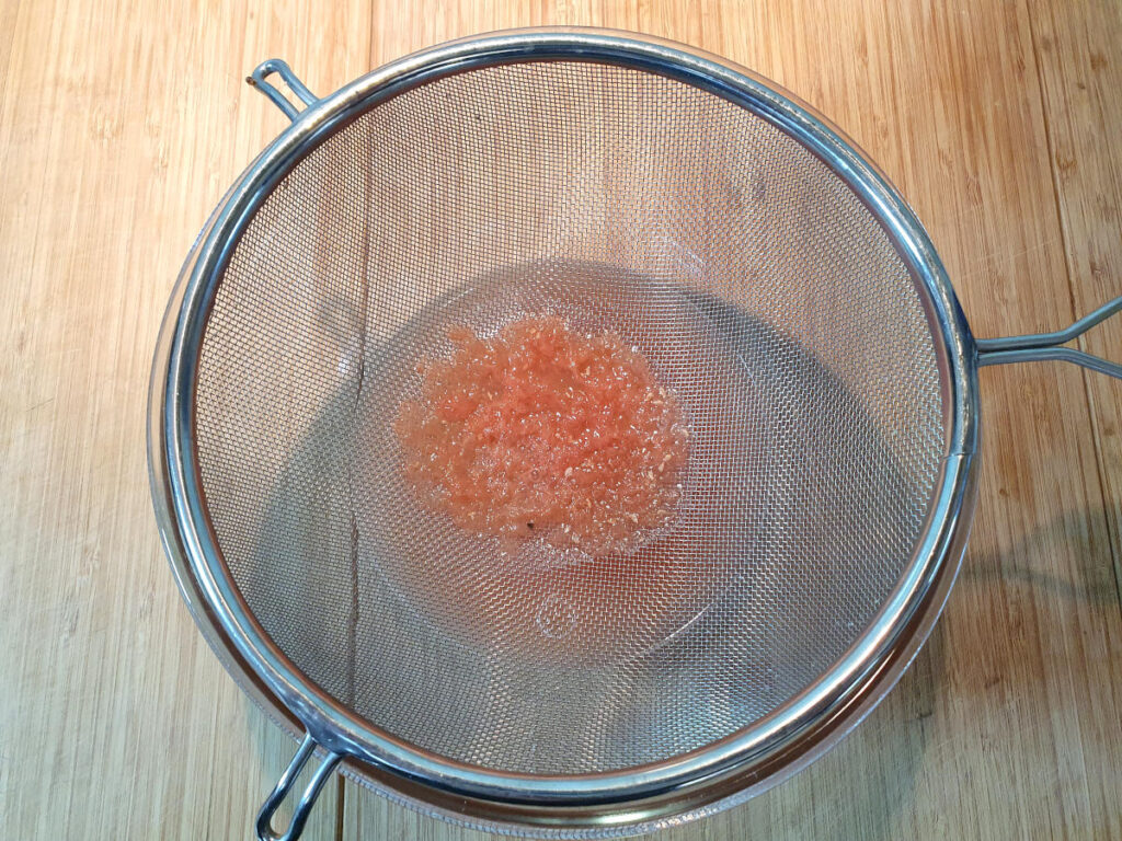 straining grapefruit juice