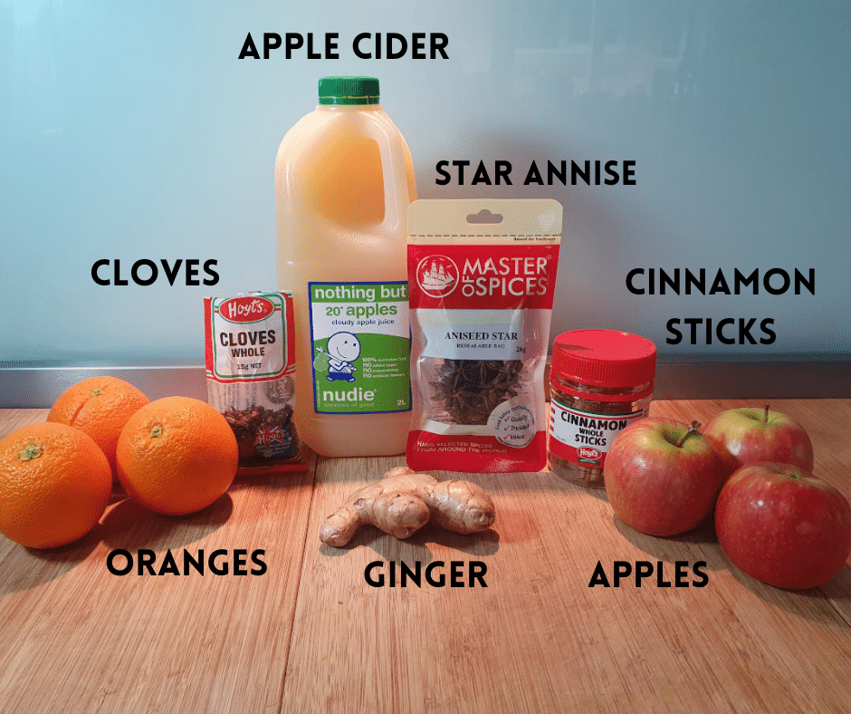 Mulled apple cider popsicle ingredients, oranges, whole cloves, ginger root, apple cider or juice, whole star anise, cinnamon sticks and apples.