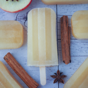 Top down view of mulled apple cider popsicle, with apple, apple star and star anise.