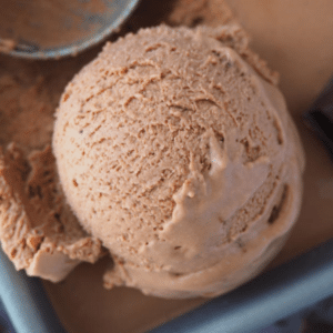 Very close up of scoop of no churn chocolate ice cream in pan.