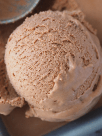 Very close up of scoop of no churn chocolate ice cream in pan.