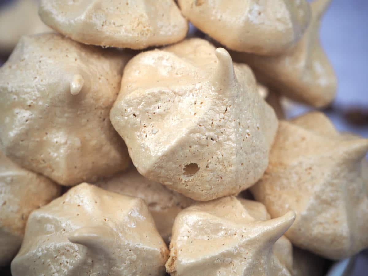 Coffee aquafaba meringues 3 close up side view of stack of coffee vegan meringues.