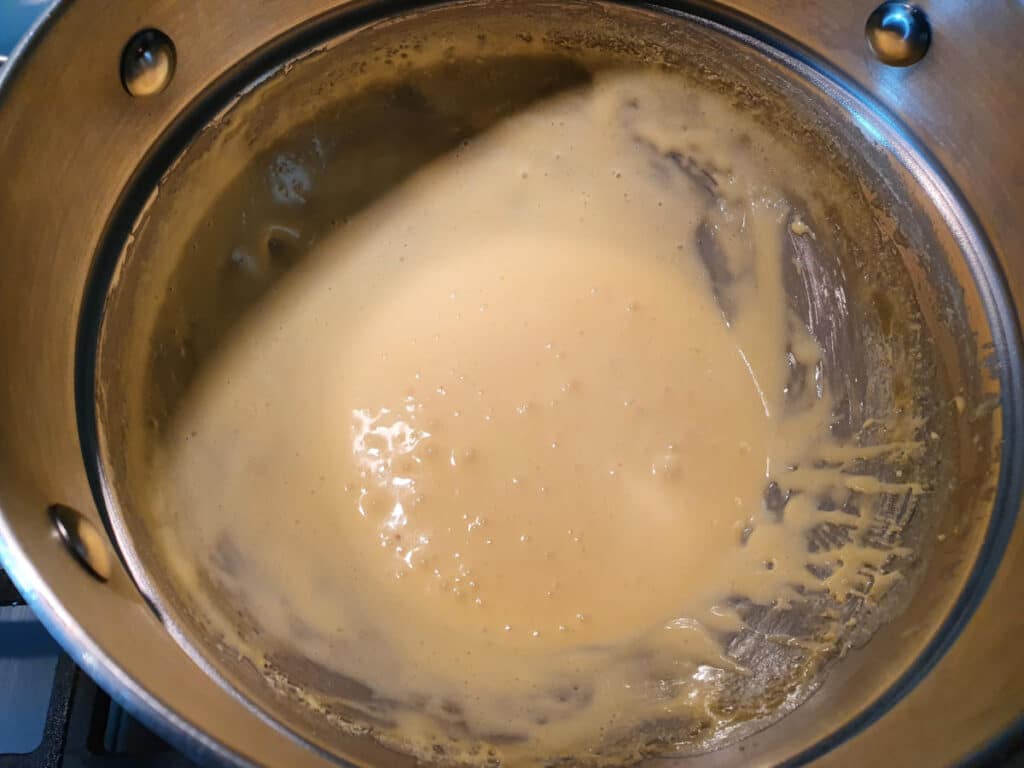 pale thickened sugar and egg yoke mix in double boiler.