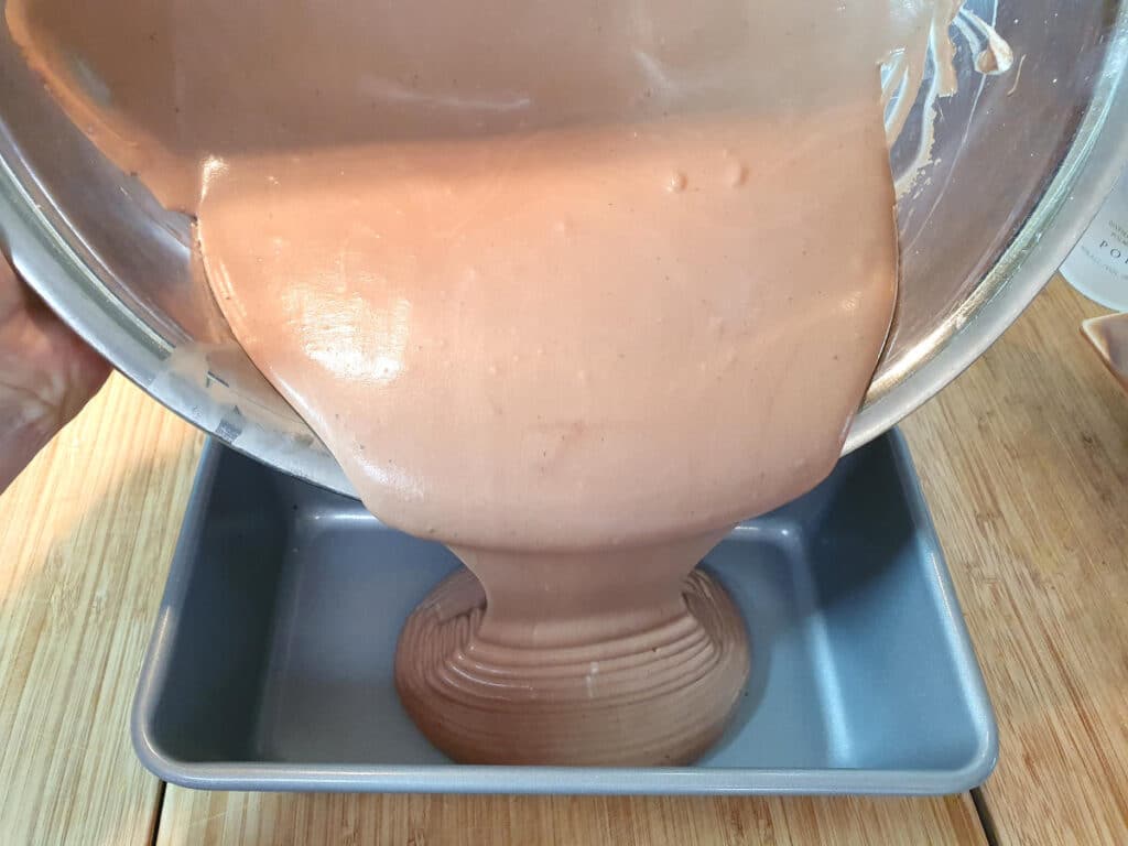 No churn chocolate ice cream 11 pouring ice cream mix into loaf pan.