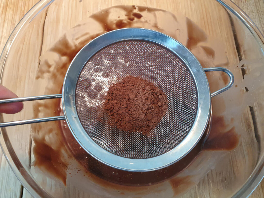 sifting coco powder into chocolate mix.