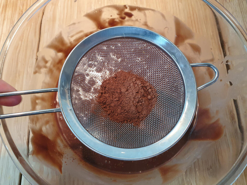 No churn chocolate ice cream 7 sifting coco powder into chocolate mix.