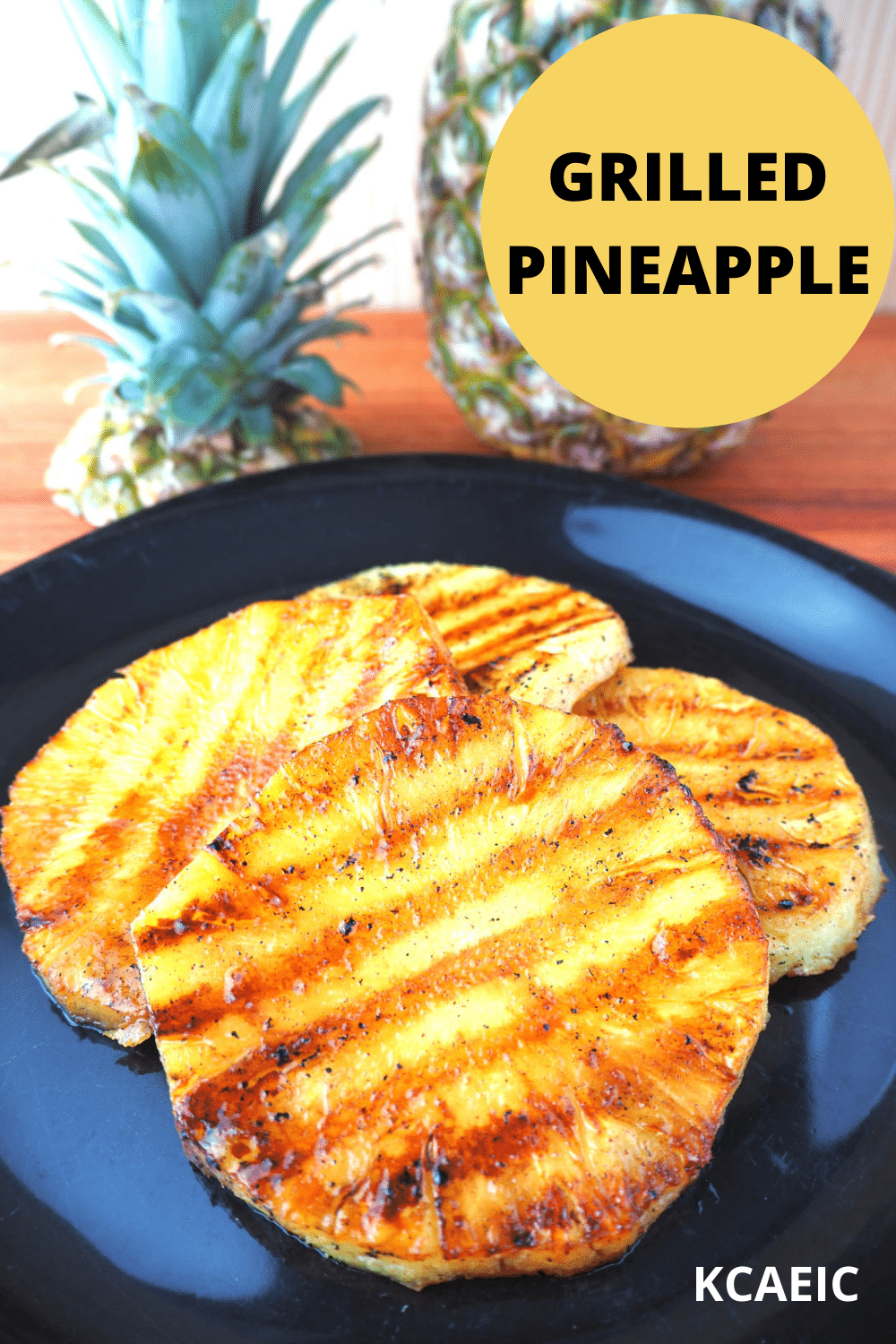 45 degree view of four grilled pineapple pices on a white plate,