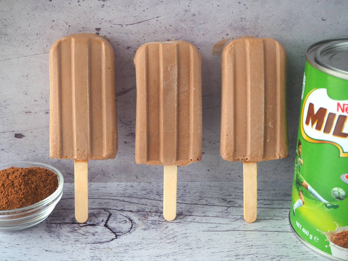 Side view of Milo icy poles with Milo tin and bowl of Milo
