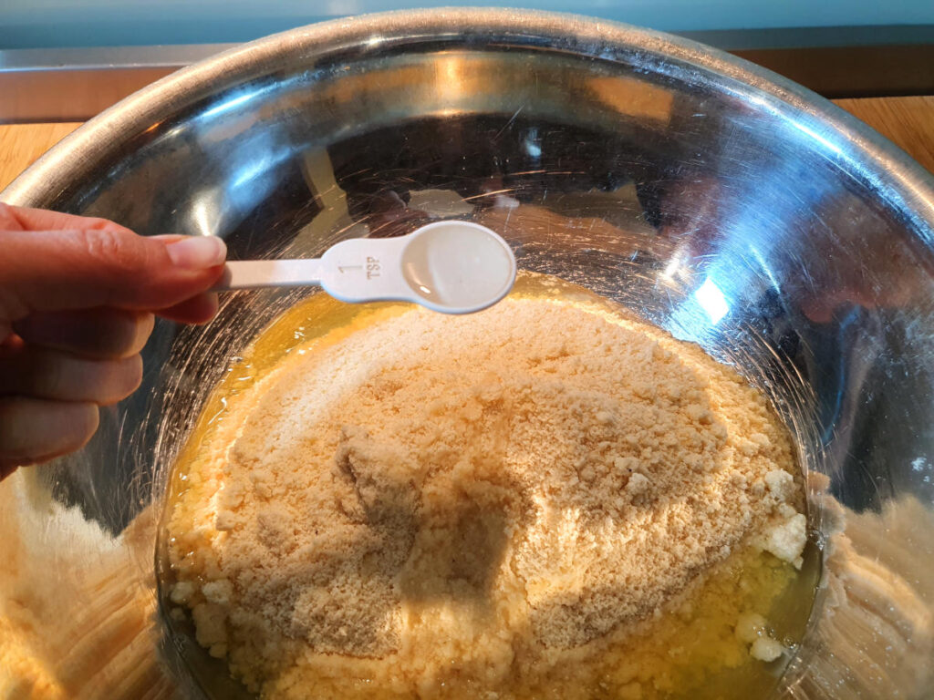 Amaretti cookies 9 adding almond essence to cookie mix.