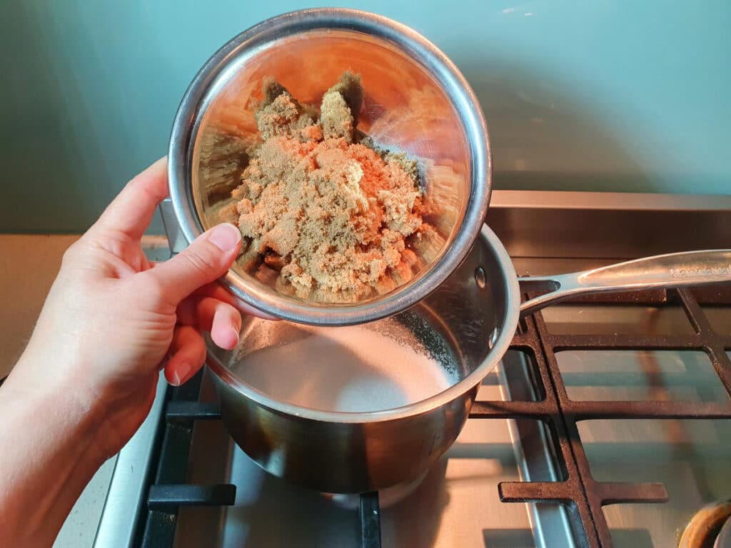 Homemade cola 6 adding brown sugar to saucepan.