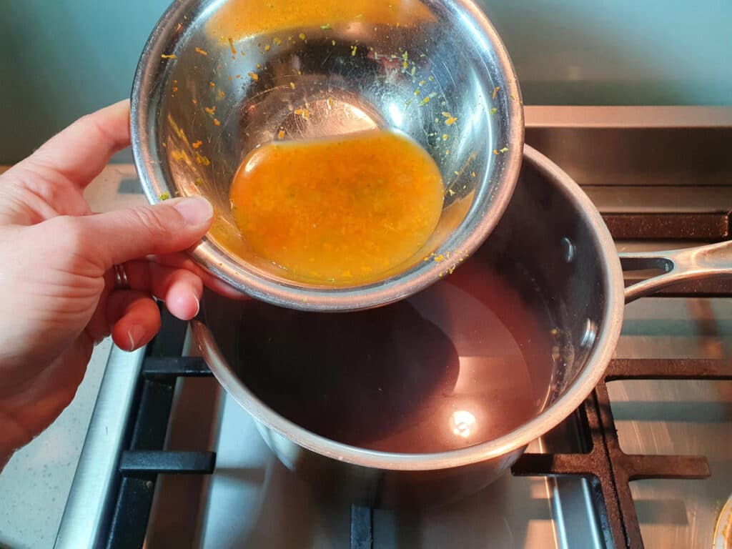 adding citrus juices and zest to saucepan.