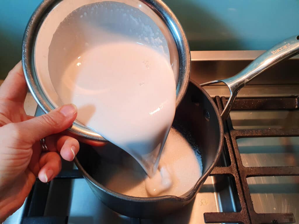 adding coconut milk to pot.