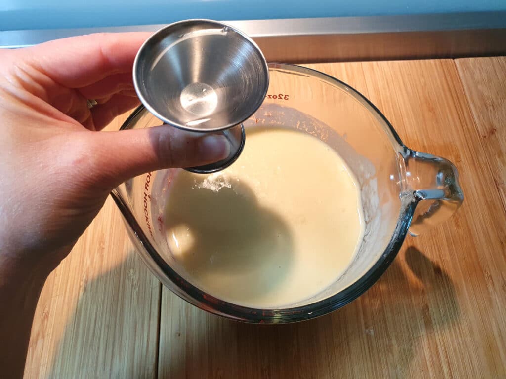 adding coconut rum to ice cream mix.