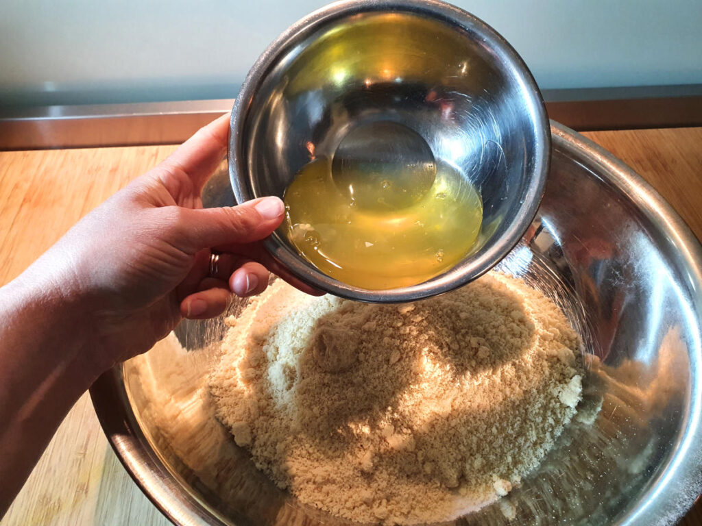 Amaretti cookies 8 adding egg whites to cookie mix.
