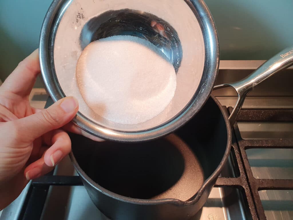 Pina colada ice cream 9 adding sugar to pot.