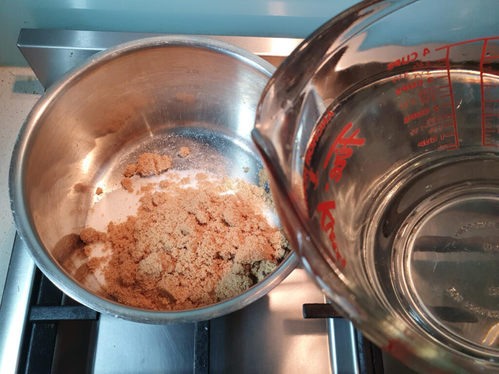 Homemade cola 7 adding water to saucepan.