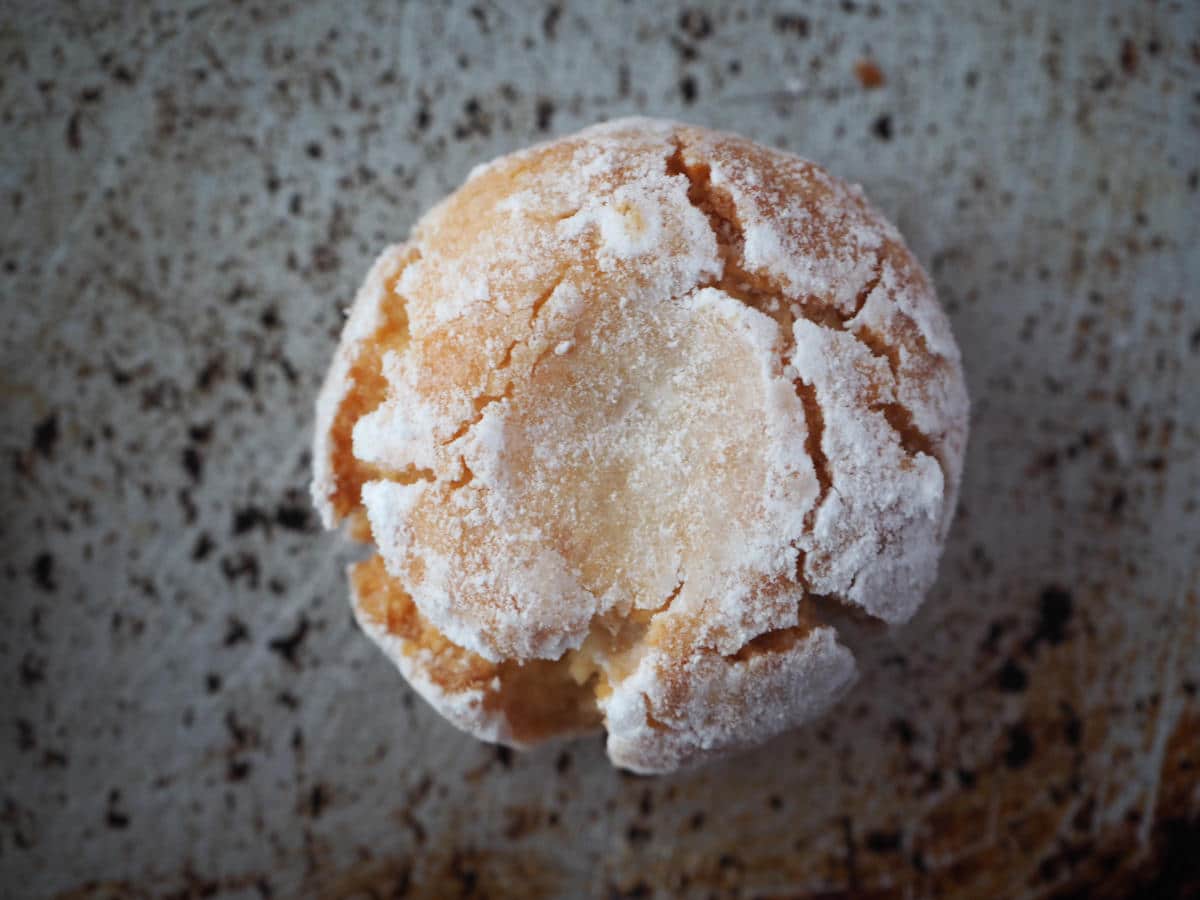 single amaretti cookie on baking tray.