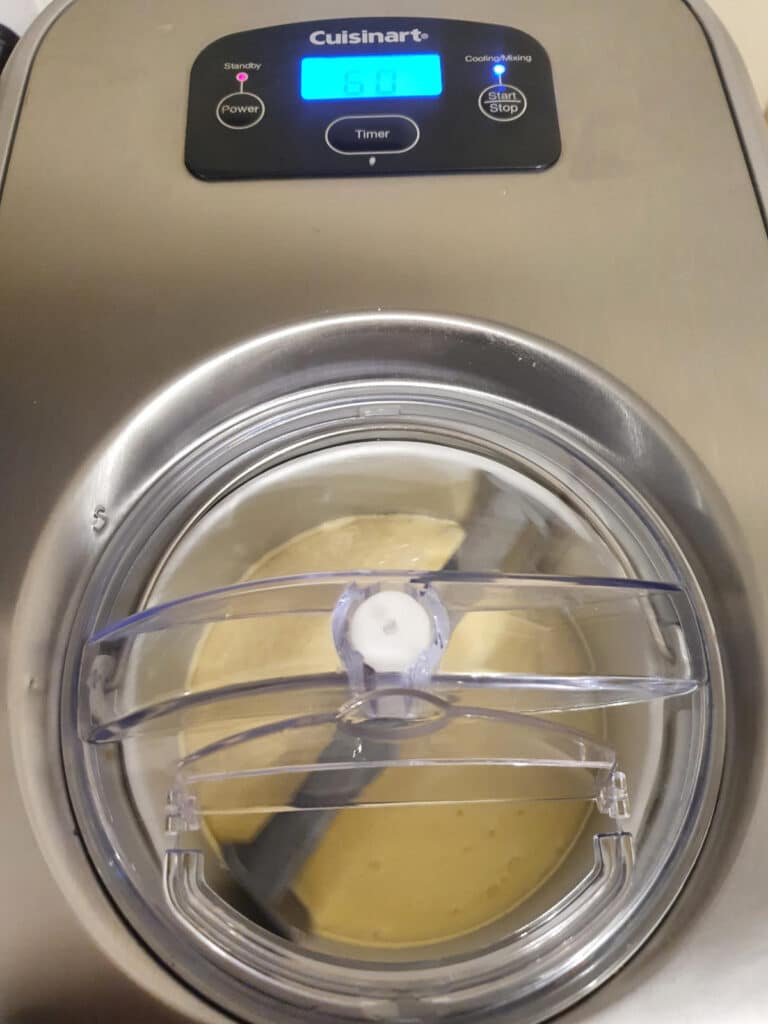 Pina colada ice cream 17 churning ice cream in ice cream machine.