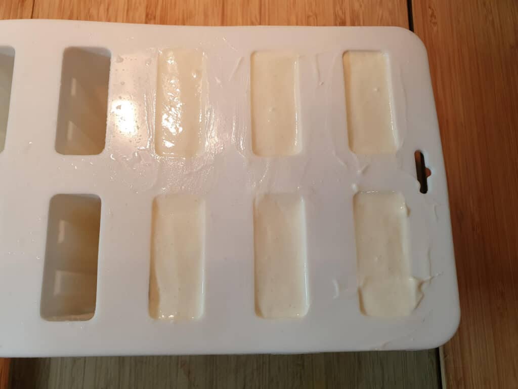 final layer of vanilla yogurt in popsicle molds.