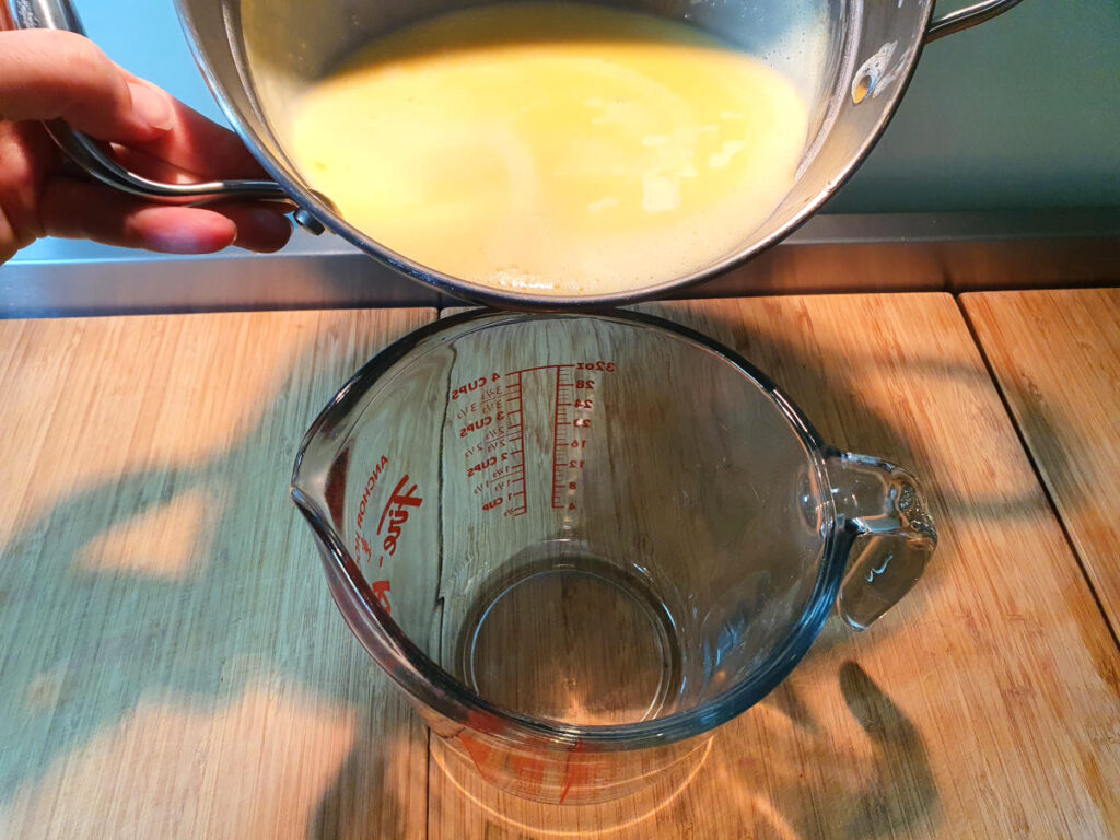 Pouring ice cream mix into heat proof metal jug.